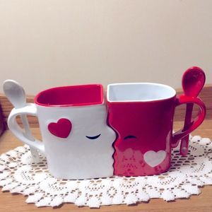 Blue Devil, Red and white Kissy mugs. 3” x 4” x 5”. Matching ceramic spoons.